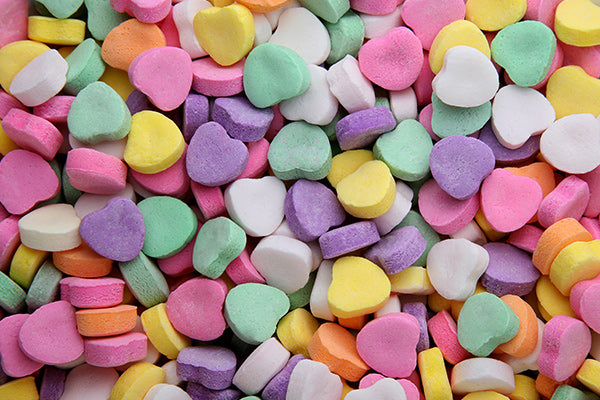 A multitude of candy sweethearts in various colors. 