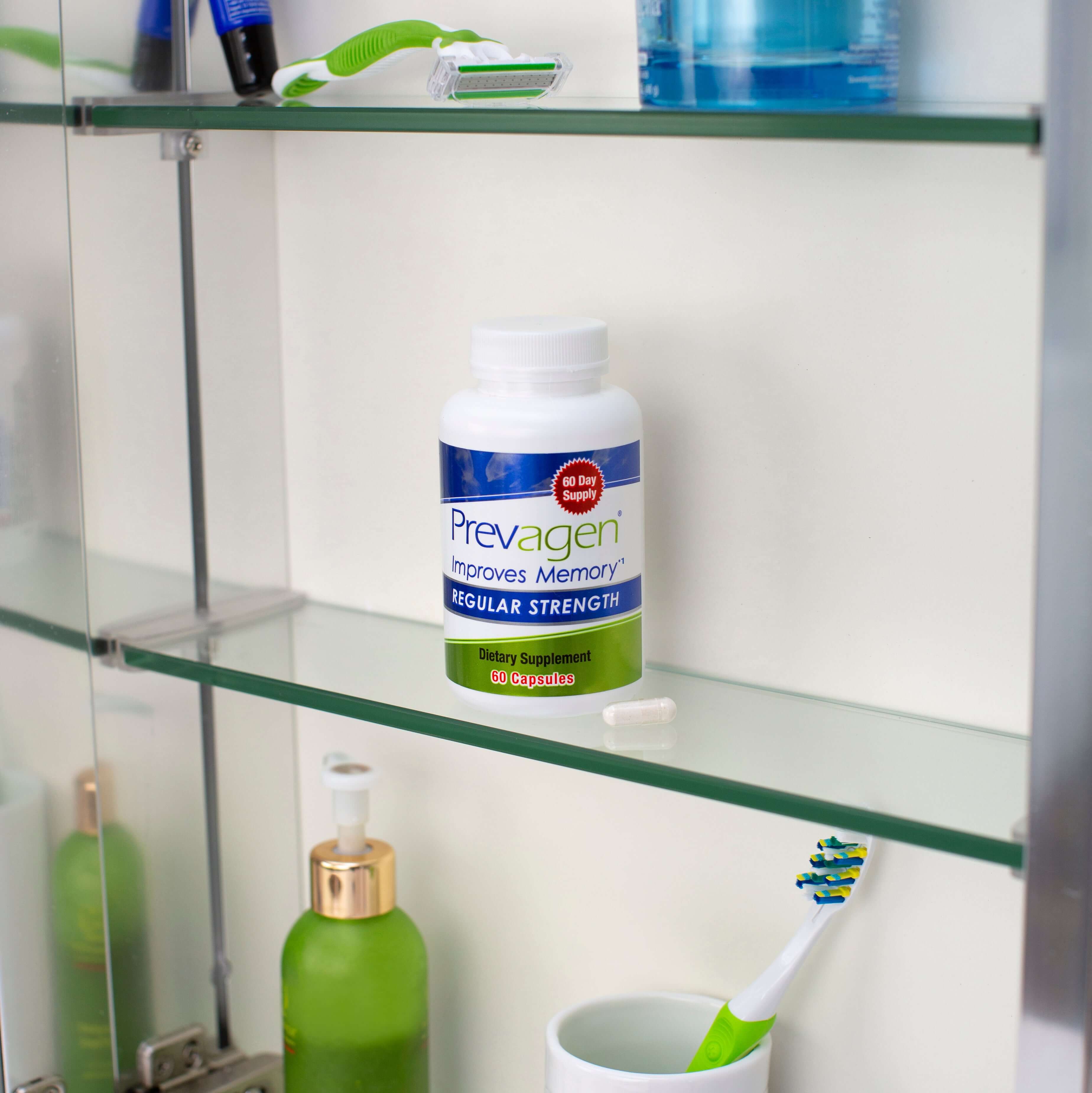 Slide 6 of 6, Bottle of Prevagen regular strength capsules in a 60 day supply on medicine cabinet shelf